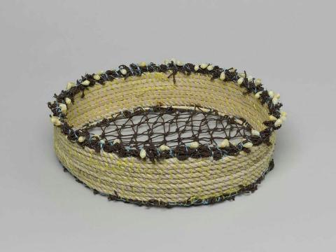 Artwork Ghost net basket with shells this artwork made of Rope, reclaimed acrylic woven fishing net, shells, cane, string, created in 2010-01-01
