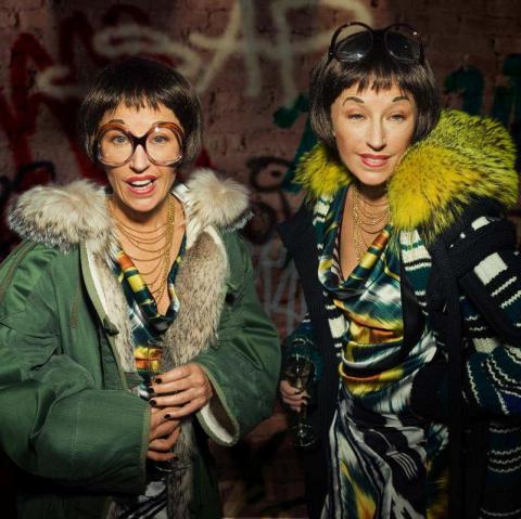 A photograph of two women so alike they must be sisters (in actuality, both are portrayed by the artist); each has a bob haircut and fur-collared jacket, with the woman on the right looking more 'dressed up'.
