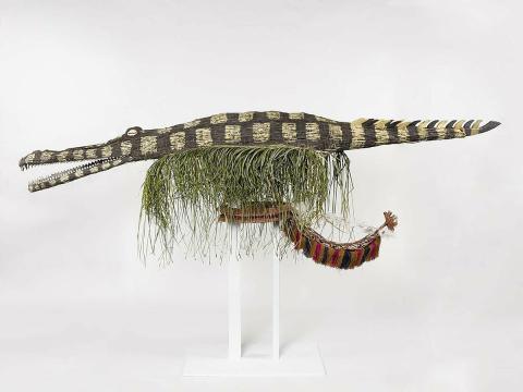 Artwork Mabutgawi (Saltwater crocodile) this artwork made of Mask: woven split cane with cowrie shells and natural ochres, cordyline leaves, grass fibres, created in 2011-01-01
