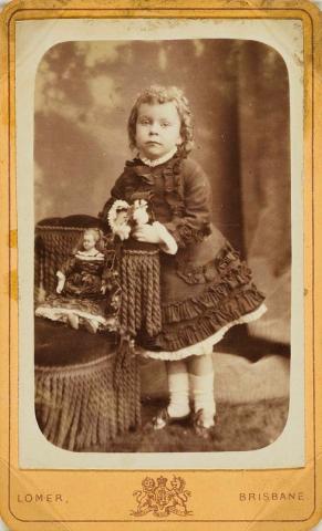 Artwork Girl with a doll this artwork made of Albumen photograph on paper mounted on card, created in 1890-01-01