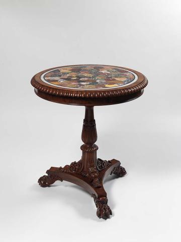 Artwork William IV pedestal table this artwork made of Rosewood with marble top; the circular top with asymmetrical specimen marble and hardstone inlay within a gadrooned border, the turned pillar with lotus and scroll carving surmounted by paterae, on a tri-form base with carved claw feet, created in 1800-01-01