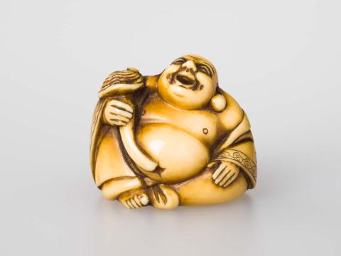 Artwork Netsuke: (Hotei holding fungus) this artwork made of Carved ivory, created in 1800-01-01
