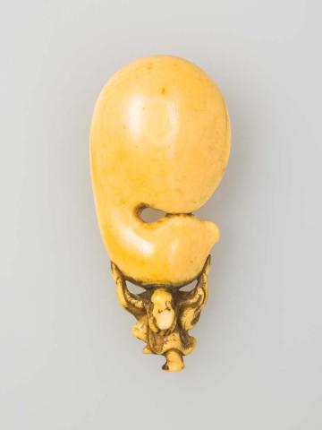 Artwork Netsuke: (figure carrying giant gourd) this artwork made of Carved ivory