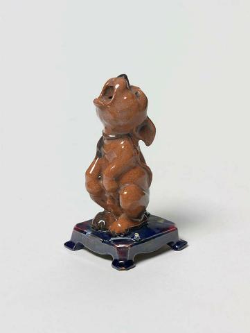 Artwork Figurine: Bonzo - Left this artwork made of Earthenware, red clay modelled as an abandoned dog with details in blue, created in 1924-01-01