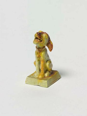 Artwork Figurine: Bonzo - A corker this artwork made of Earthenware, press moulded in the form of a seated dog with brown glaze splashed over green and yellow, created in 1920-01-01