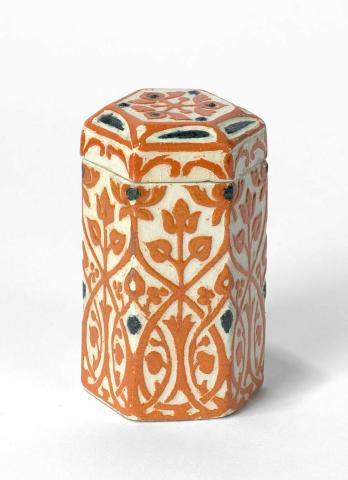 Artwork Hexagonal canister this artwork made of Earthenware, slab built and dipped gold and terracotta slips and incised with arabesque design, created in 1934-01-01