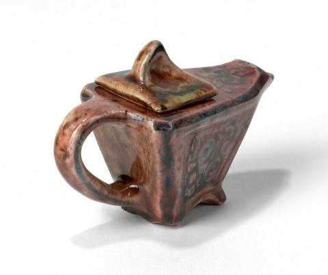 Artwork Miniature triangular teapot this artwork made of Earthenware, slip cast and carved with floral motifs, pink glaze with blue details, created in 1930-01-01