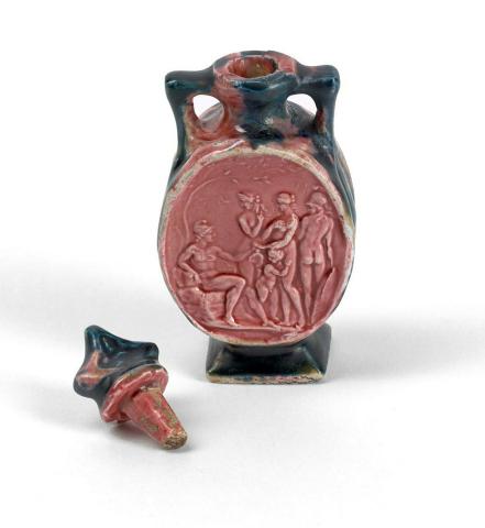 Artwork Flask with cameo this artwork made of Earthenware, modelled with five figures and glazed pink. Verso carved with foliate motifs and blue and pink glaze, created in 1920-01-01