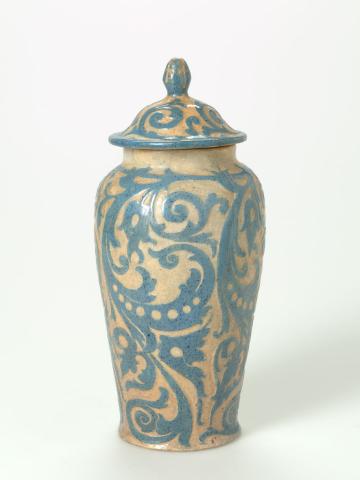 Artwork Covered baluster jar this artwork made of Earthenware, hand-built pie-dish clay dipped blue slip and carved with scrolls beneath a clear glaze, created in 1937-01-01