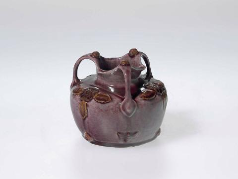 Artwork Rose bowl this artwork made of Earthenware, modelled with three handles and three formalised Tudor roses in a deep mulberry glaze, created in 1920-01-01