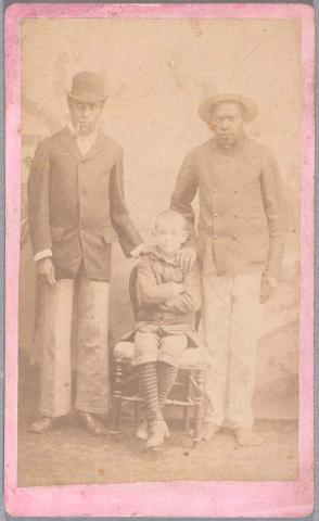 Artwork Two New Caledonian men and European boy this artwork made of Albumen photograph on paper mounted on card, created in 1865-01-01