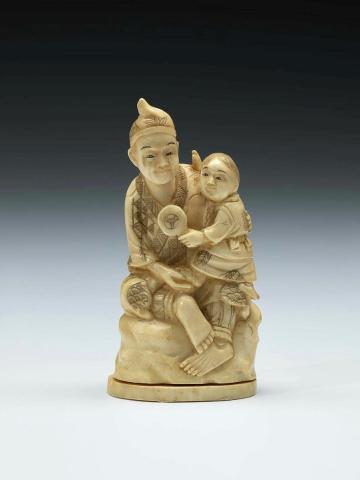 Artwork (Figure of a man and child) this artwork made of Ivory carved with black details.  Separate base, created in 1800-01-01