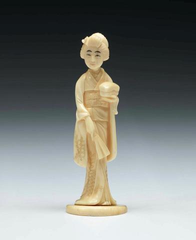 Artwork (Figure of a woman in a kimono) this artwork made of Ivory, carved and incised with details in black pigment, created in 1800-01-01