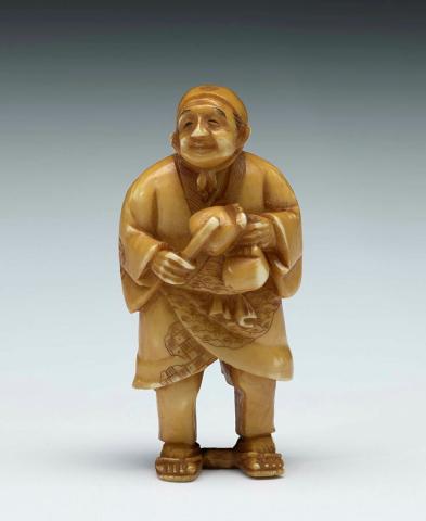Artwork Netsuke:  (man wearing scarf around head) this artwork made of Ivory, carved and incised, created in 1800-01-01