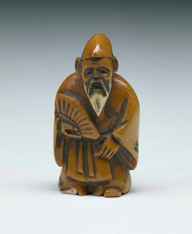 Artwork Netsuke:  (bearded man with fan) this artwork made of Ivory, carved and incised, created in 1800-01-01