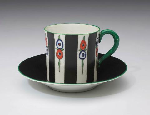 Artwork Coffee cup and saucer this artwork made of Bone china painted with broad black stripes and stylised flowers in red and royal blue between green rim and handle.  The black saucer with a floral centre in the art deco taste, created in 1919-01-01