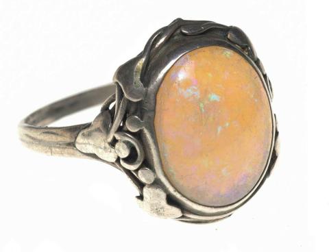 Artwork Ring this artwork made of Oval milky opal framed with silver tendrils and three ivy leaves at the shoulder in the arts and crafts manner, created in 1940-01-01