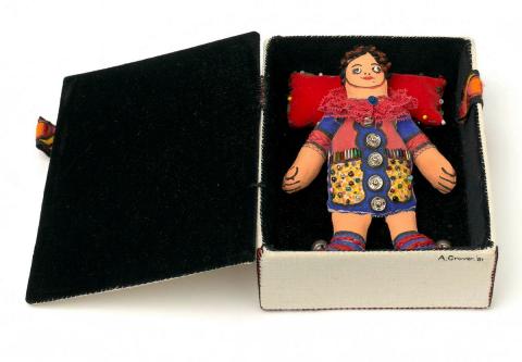 Artwork Sculpture: Clown doll in box this artwork made of Fabric covered box lined black velvet enclosing clown doll in calico, lace, beads, buttons and embroidery
