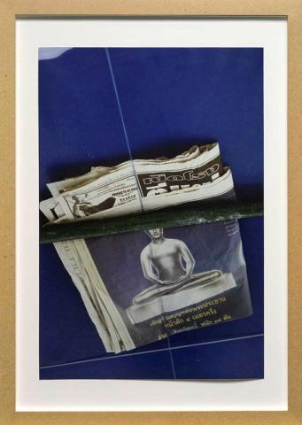 Artwork Untitled (Buddha newspaper) this artwork made of Ultra-glossy type C photograph on paper in medium density fibreboard frame, created in 1998-01-01