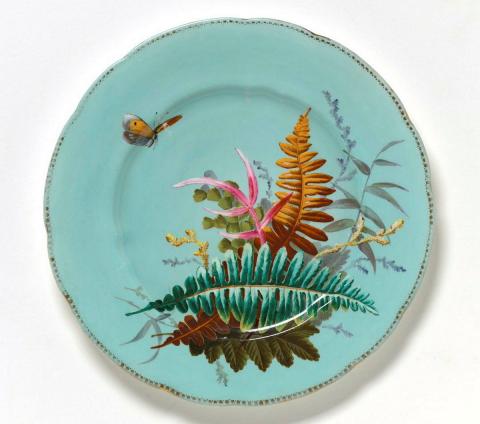 Artwork Plate this artwork made of Porcelain (bone china) the blue ground painted in overglaze colours with naturalistic ferns and butterflies. Gilt dentil edge, created in 1851-01-01