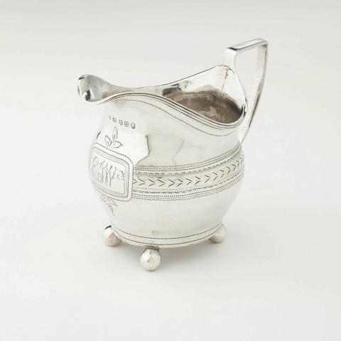Artwork Cream jug this artwork made of Silver, ball feet with a simple foliate band engraved around body, created in 1789-01-01