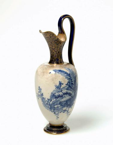 Artwork Ewer this artwork made of Porcelain (parian) the oviform body with stepped base and curving handle printed in cobalt underglaze with a group of ferns on a stippled gold ground. A gold paisley print on neck and base, created in 1891-01-01