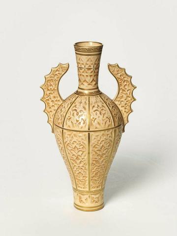 Artwork Vase this artwork made of Porcelain (parian) slip-cast moulded stylised foliage and decorated batwing handles in the Persian style. Sprayed brown with gilt lines