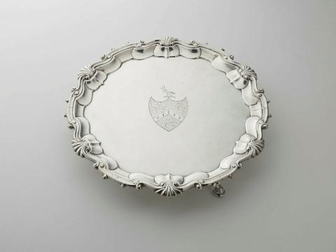Artwork Salver this artwork made of Silver with scroll edges and Central shield engraved with three bird ornaments, created in 1746-01-01