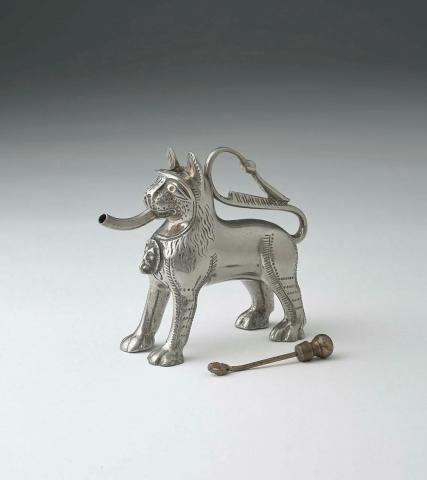 Artwork Aquamanile and stopper this artwork made of Silver (?) and brass cast in the form of a lion