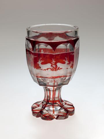 Artwork Goblet this artwork made of Clear glass stained red and engraved with a hunting scene;  star pattern on base, created in 1840-01-01