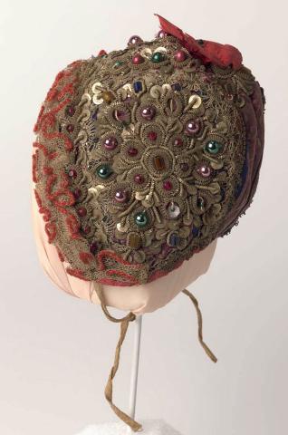 Artwork Baby's christening bonnet this artwork made of Silk brocade embroidered with metal beads, sequins and glass beads and edged with machine made lace, created in 1800-01-01