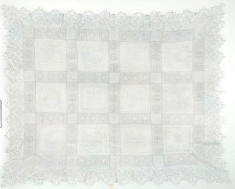 Artwork Whitework tablecloth this artwork made of Alternating panels of hand embroidered white linen and squares of darned lace work. Border (11cm) of coarse bobbin lace