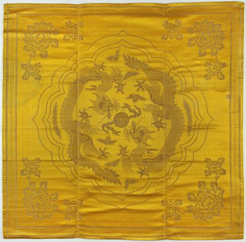 Artwork Table cover this artwork made of Yellow silk and metal thread brocade with flower and dragon pattern, created in 1900-01-01