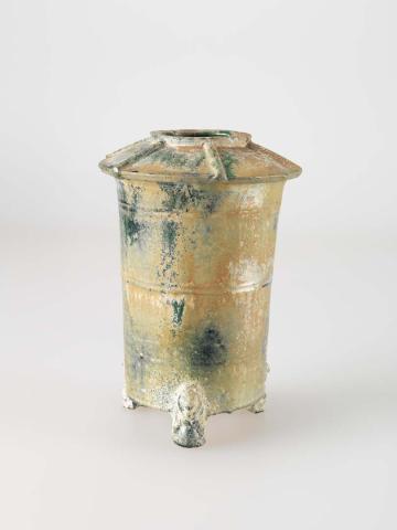 Artwork Granary jar this artwork made of Tall spreading cylindrical stoneware body, the narrow opening decorated with radial ridges, set on three bear feet with a degraded green glaze, created in 0025-01-01