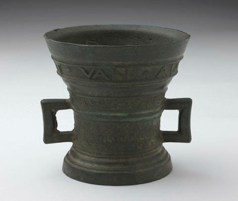 Artwork Mortar this artwork made of Cast flaring cylindrical bronze shape with square big handles and bands of foliate designs, created in 1603-01-01