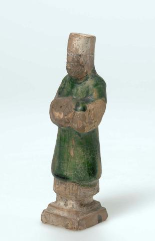 Artwork Tomb figure: (Central Asian groom) this artwork made of Earthenware, modelled with a degraded straw coloured glaze, created in 0618-01-01