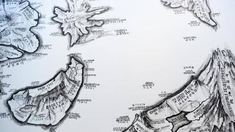 An installation view of part of a map painted directly on a white wall at GOMA.