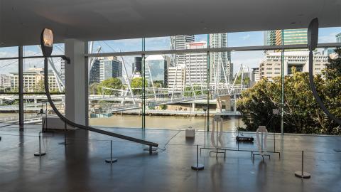 An installation view of a sculptural work installed at GOMA next to a window overlooking the Brisbane River.