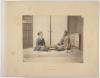 Faded 19th century Japanese photo of two people seated, meeting
