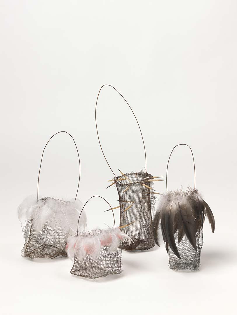 A group of baskets made from wire and feathers.