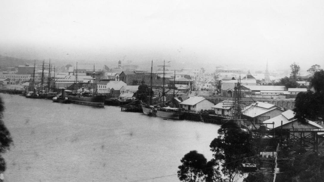A black-and-white photograph of the Brisbane River photographed in 1883, looking up Queen Street and featuring Old Custom's House.