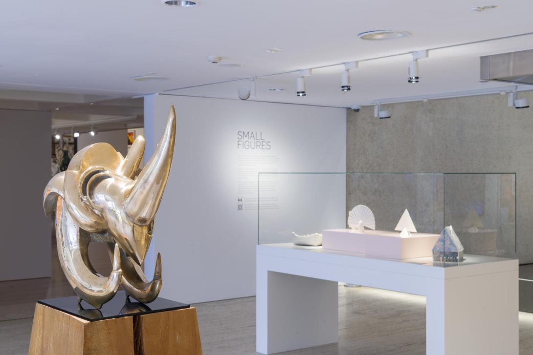 An installation view of a bright gallery space with sculptural works on display.