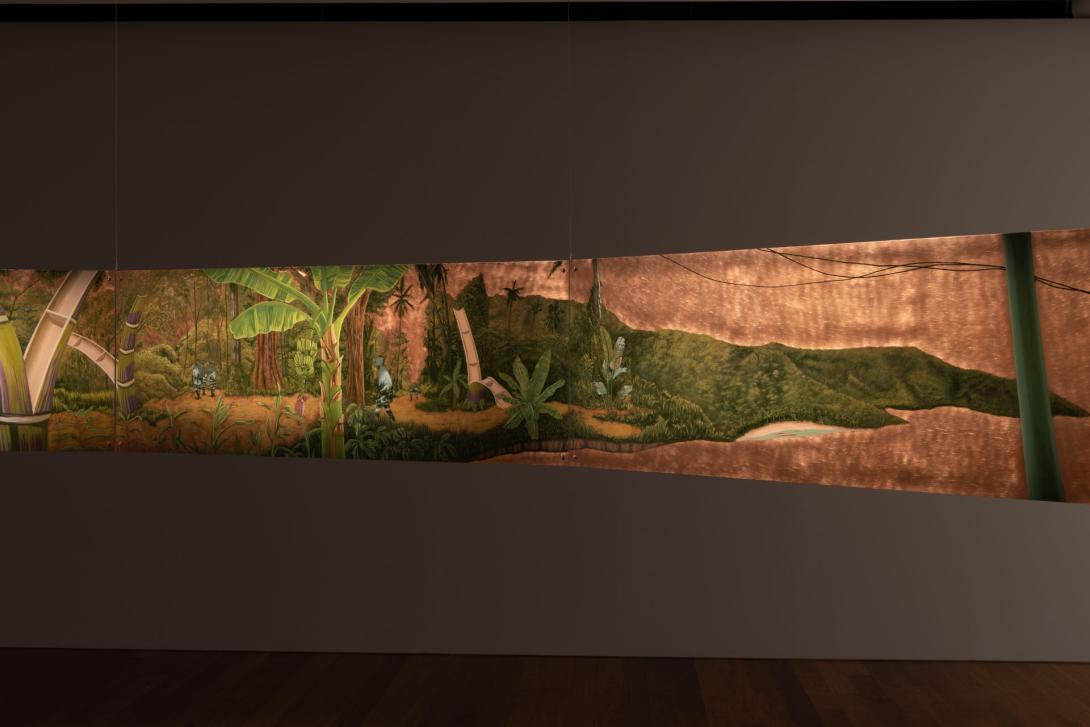 An installation view of a work painted on copper by Lee Paje, in which silhouetted figures emerge from bamboo shoots. The edges of another copper work, suspended, can be seen at left and right.