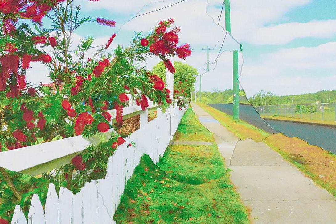 A detail view of a collaged photograph of a suburban street in Cherbourg, with the photo appearing to be cracked like a window or mirror