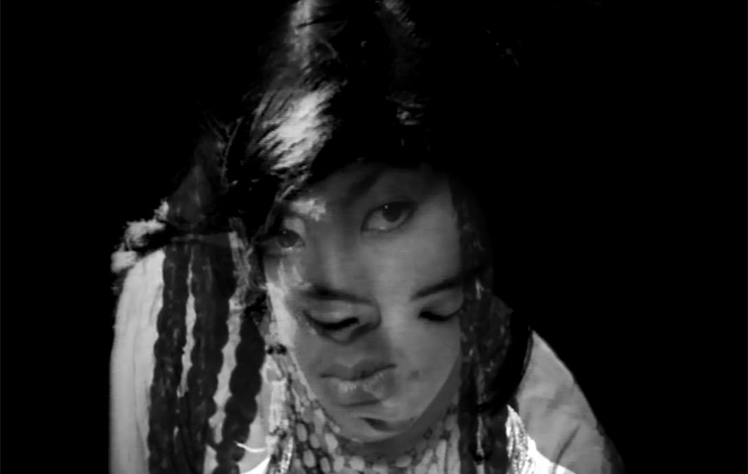 A still from a black-and-white film, featuring a young girl in motion
