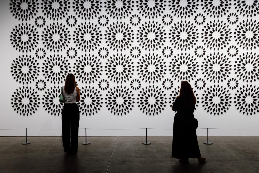 A view of a vast ceramics installation on a gallery wall