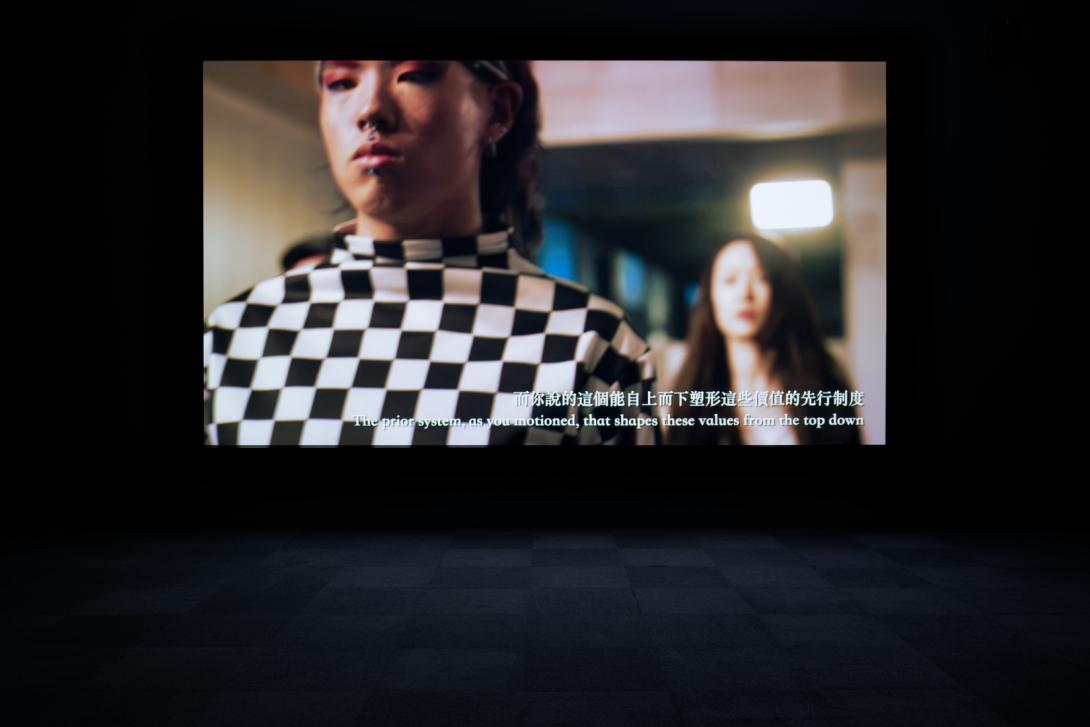 A view of a film being screened in a dark gallery space