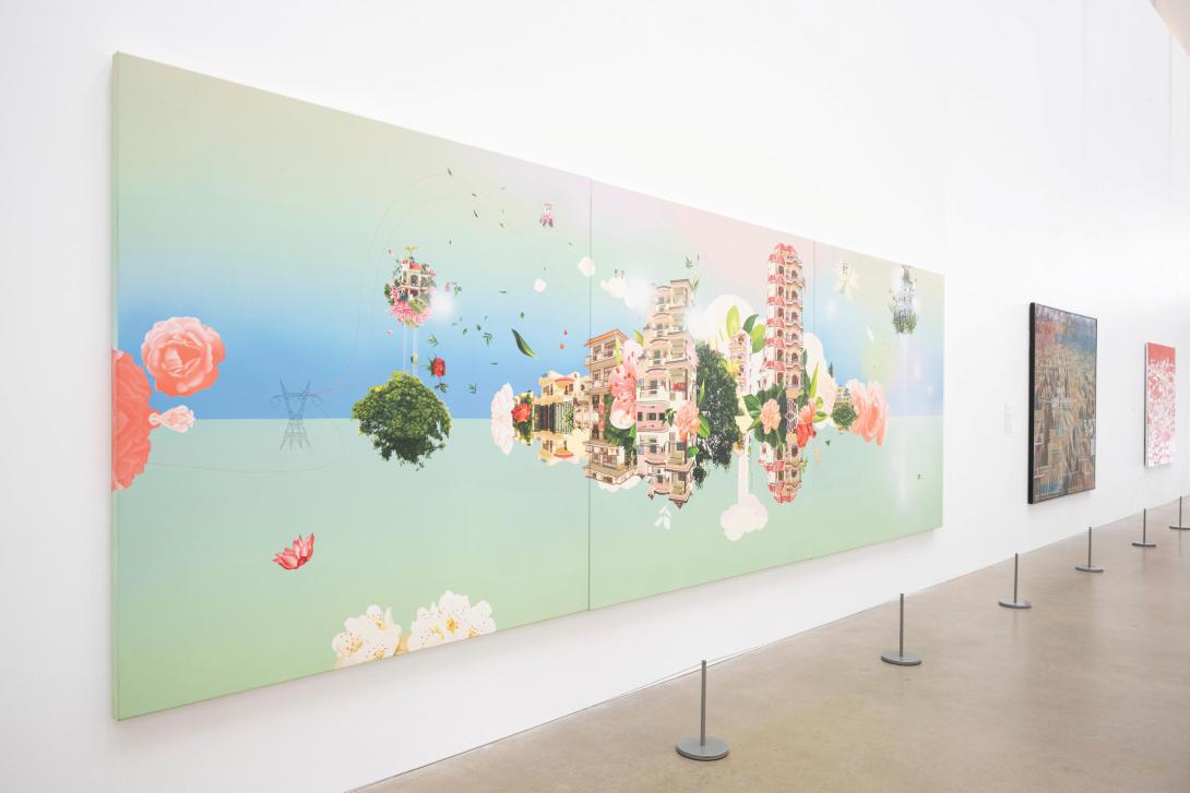 Three large, bright paintings installed on a white gallery wall