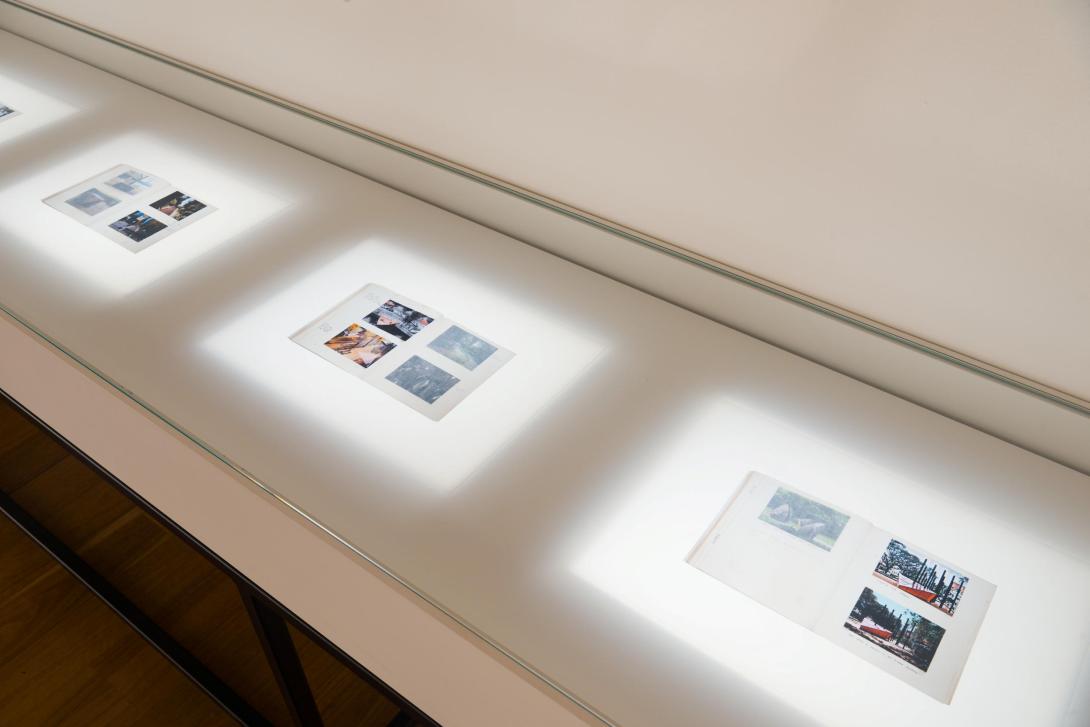 A series of works on paper installed in a gallery vitrine, with backlighting