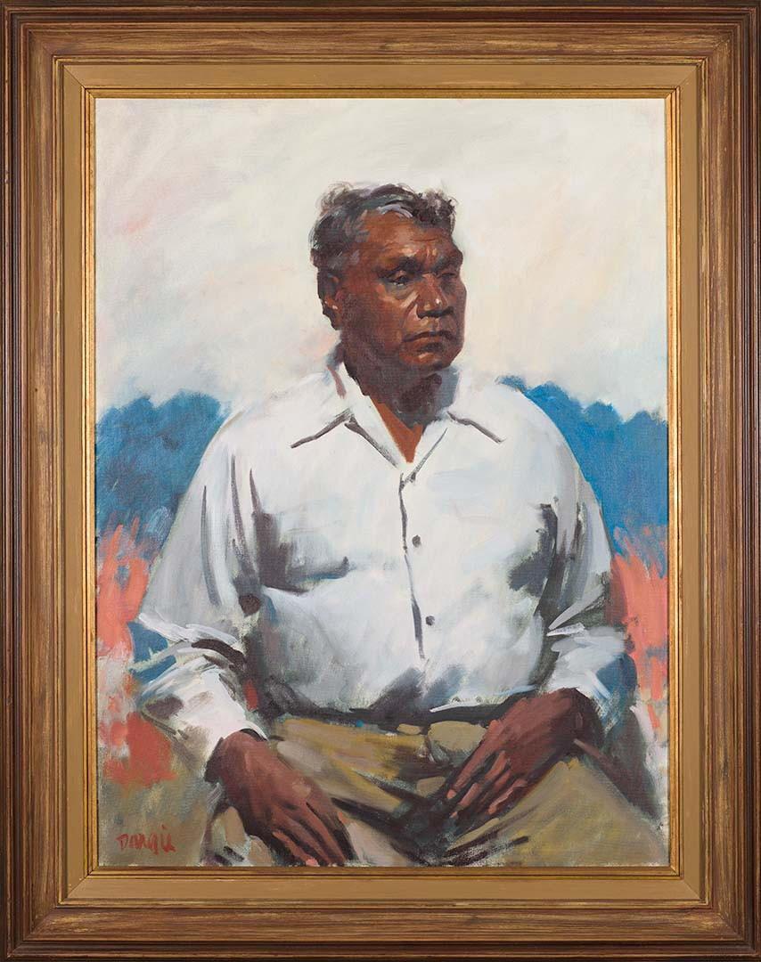 A portrait of an Aboriginal man, with an Australian desert landscape in the background, and with a gold frame.
